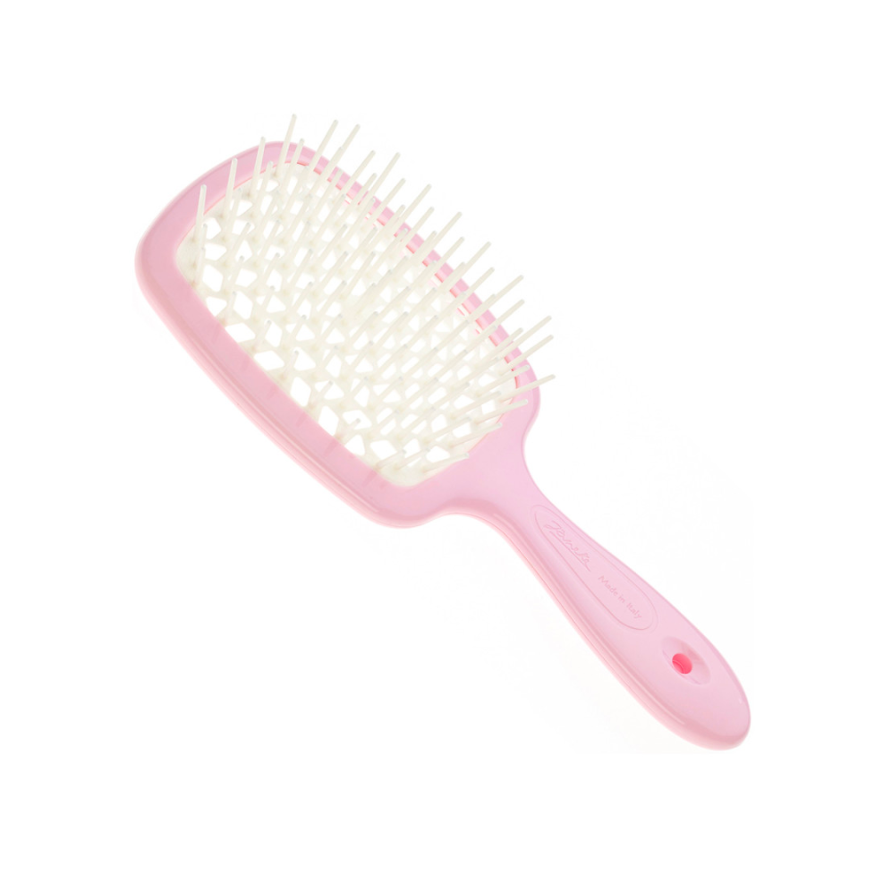 Pink paddle hairbrush on a white background