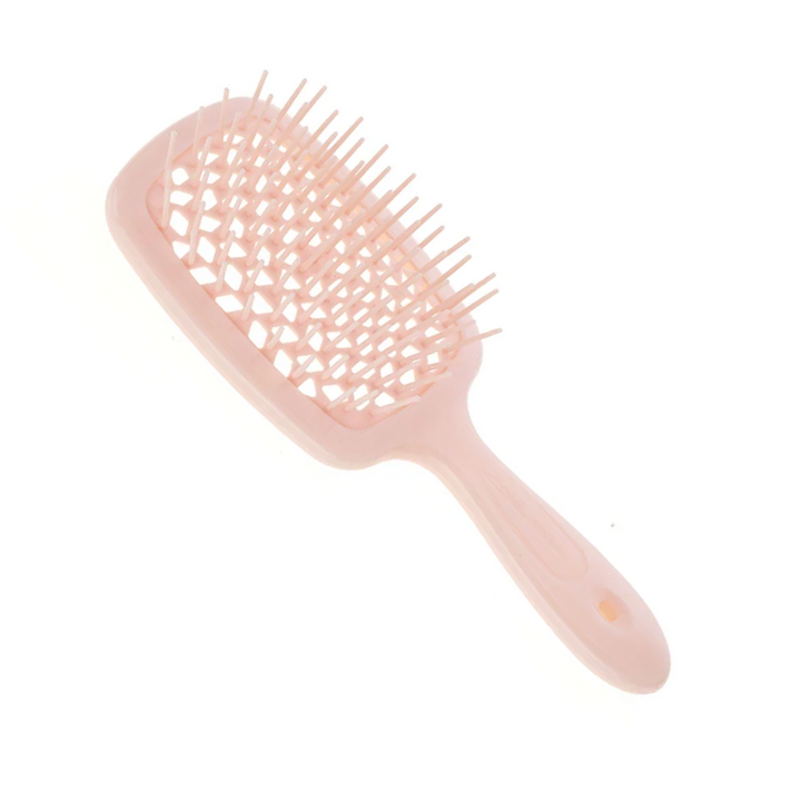 Pink hairbrush with a textured handle on a white background