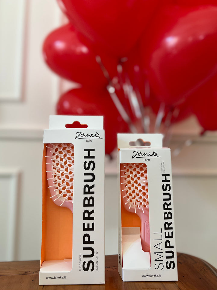 Two boxes of Janeko Superbrushes with red balloons in the background